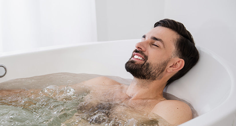 Man relaxing in bath with CBD bath salts.