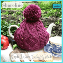 A stunning plum coloured hand crafted aran style tea cosy with bobble from Shoreline - Parade Handmade