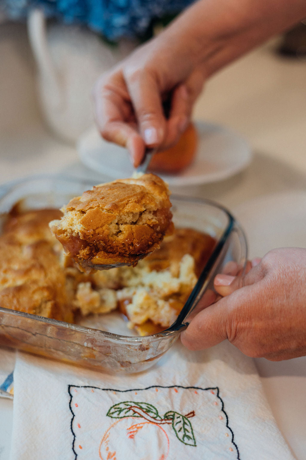 Michelle Sirles of Rendleman Orchards scoops fresh homemade peach cobbler.