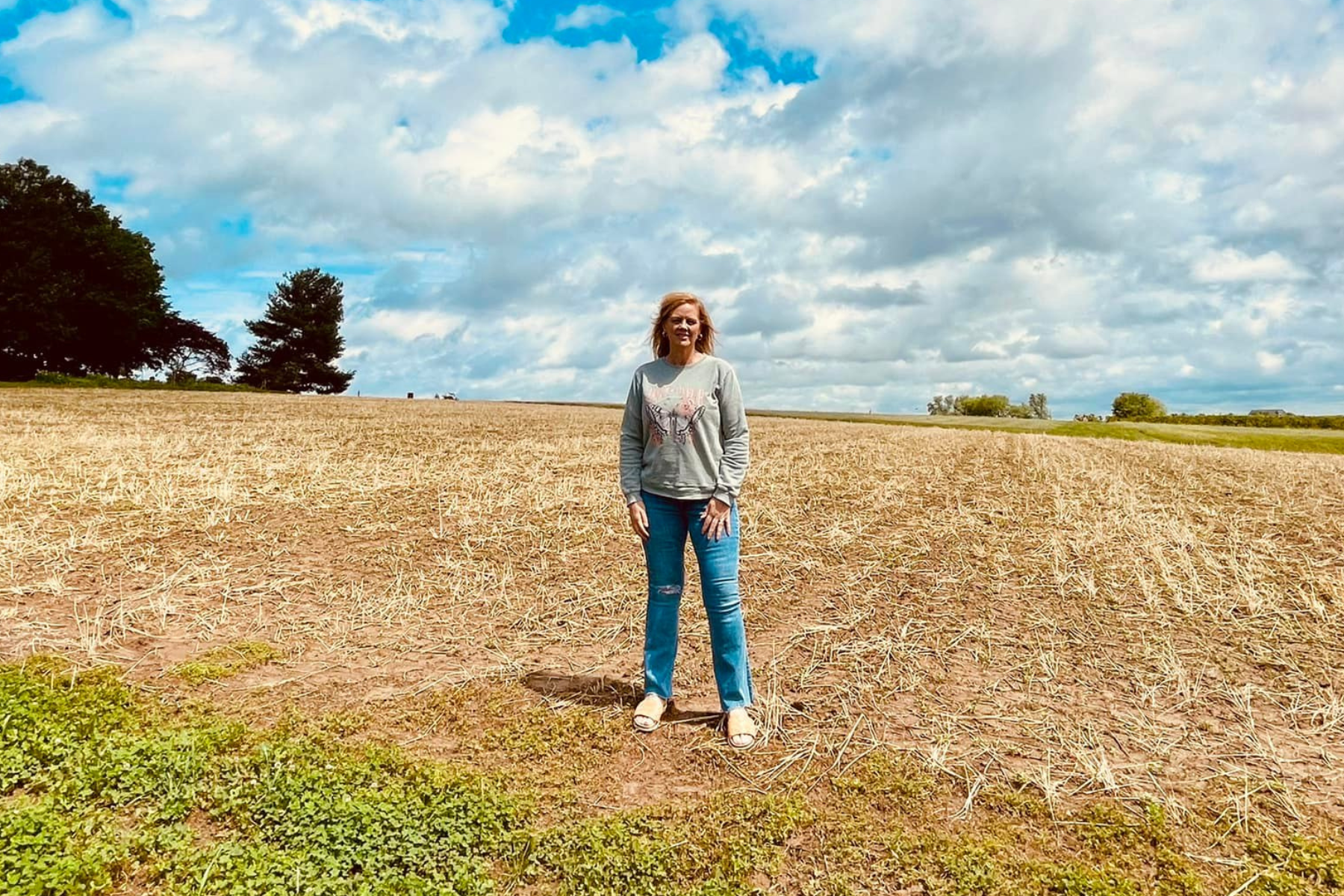 Michelle Sirles stands in empty field preparing for Zinnia flowers at Rendleman Orchards.