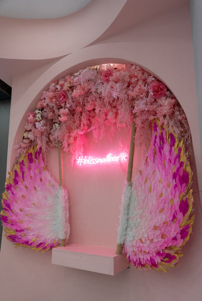 Bliss Nail Bar in Round Rock, Texas. Beautiful flower wall with wings for customers to take pictures at.