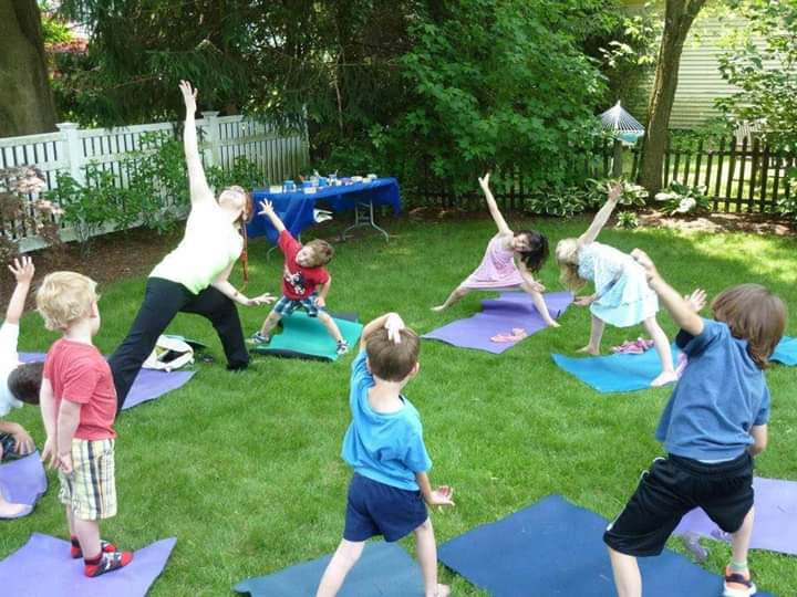 Lara Hocheiser leading an outdoor yoga birthday party for Kids