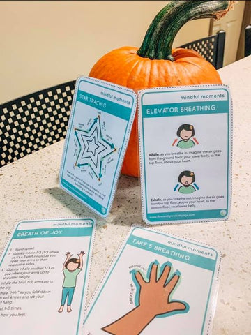 Mindful Moments Activity Cards displayed on a pumpkin as a stand