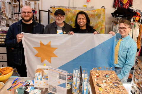 Jacob Parr, Jeff Ball, Remy Darby and Alan Dow pose with the proposed Toledo flag at House of Dow.