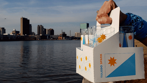 A GIF animation of the Toledo Sparks Drinkware set features the city's downtown skyline reflecting in the Maumee River.