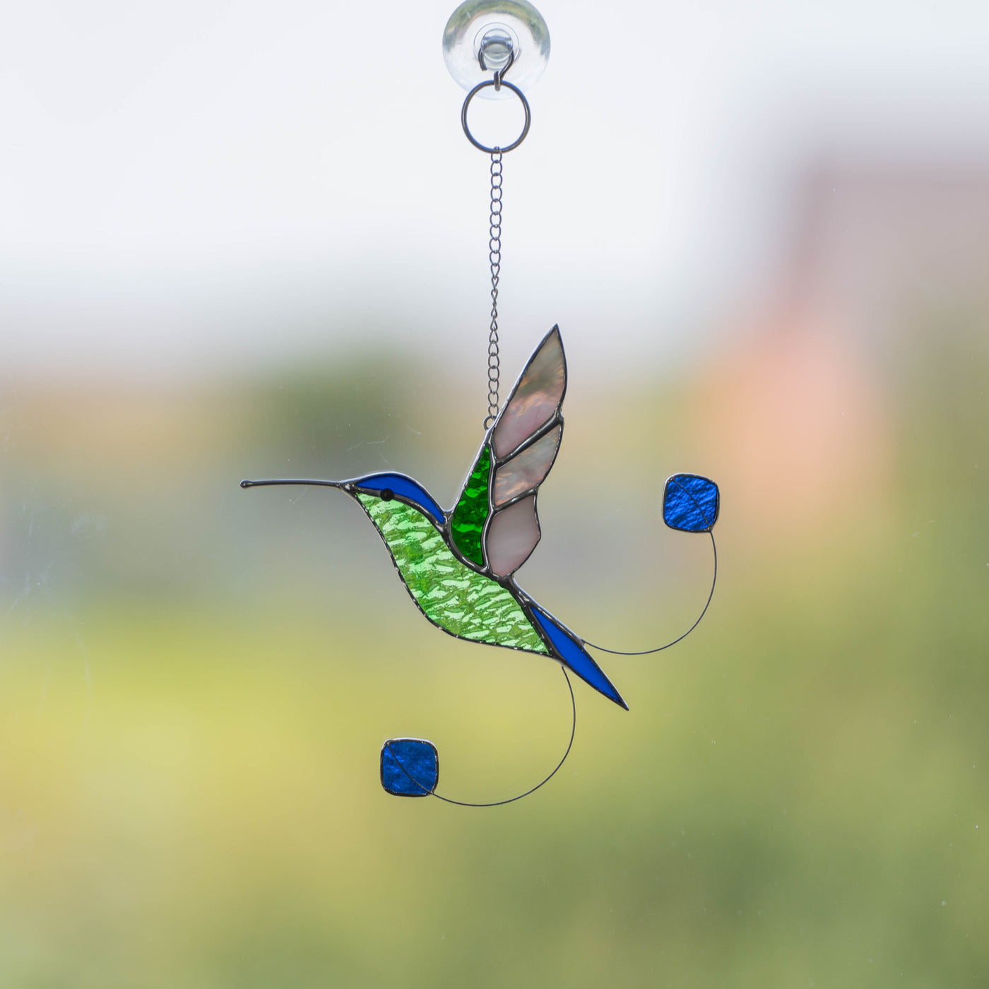 Blue booted racket-tail hummingbird stained glass suncatcher