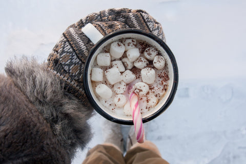 hot cocoa; mittens holding hot cup; marshmallows inside.