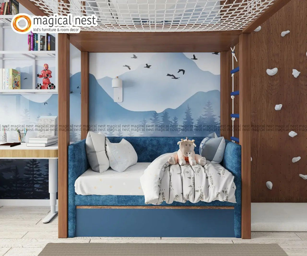 A Blue-themed room with rock climbing by the bed and a rope walk over and a study table.