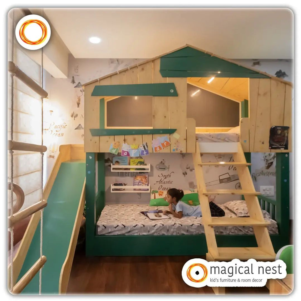 A loft bed with a slide and a girl relaxing on the comfortable bed reading a book.