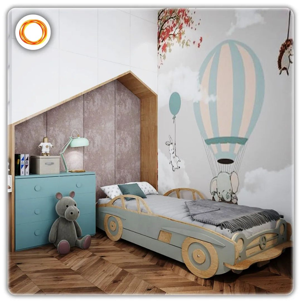 A cute wooden car bed against a parachute wallpaper and chest of draws by the bed.