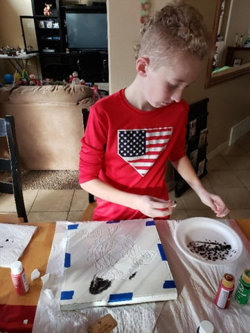 Tate making grandmas gift.