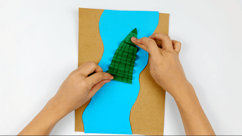 Folding paper crocodile into an accordion shape for paper nile crocodile craft