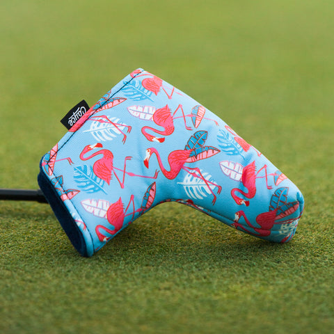 flamingo blade putter cover laying on the golf green