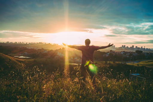 Man stretching in the sunset