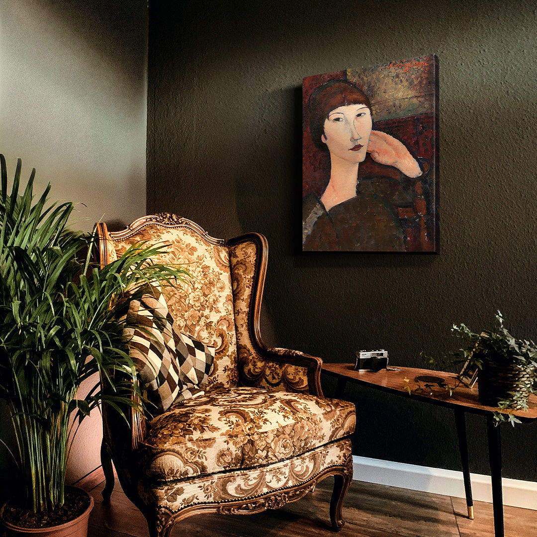 Adrienne by Amedeo Modigliani on a dark wall next to a chair