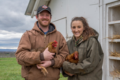 Allison and Josh holding Welsummer chickens