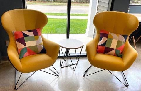 Quality Office Environments chairs with bold patterned pillows