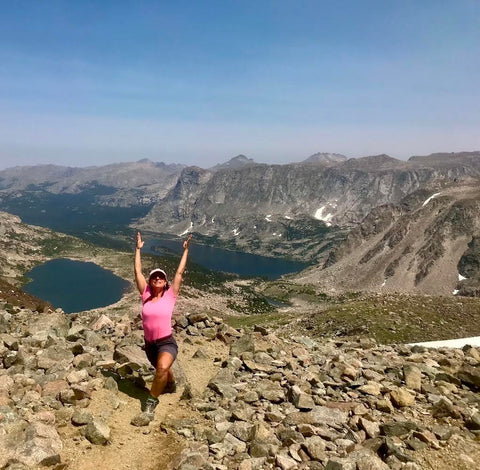 Deb French in yoga pose on world travels