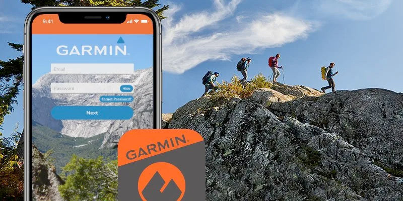 Hikers climbing a mountain with phone displaying Garmin app in the foreground