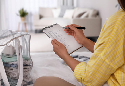 pregnant woman going through a checklist for her hospital bag