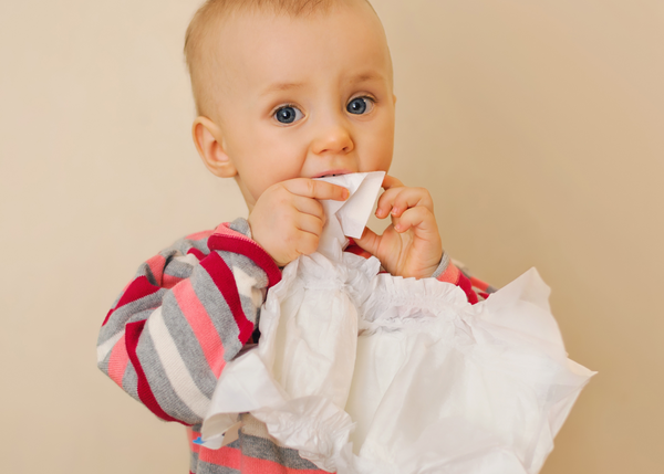 A little toddler playing with his dry nappy