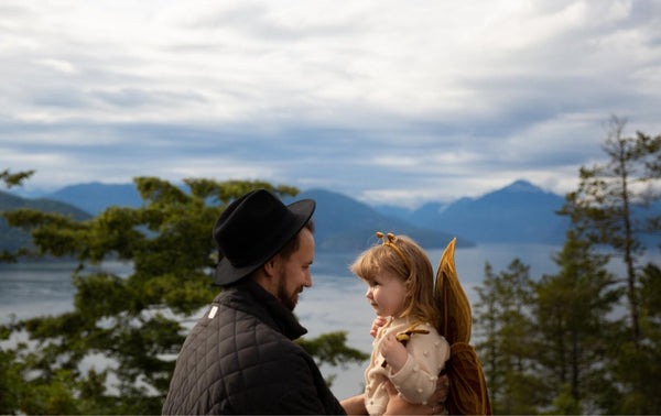 Father and little daughter camping at lake