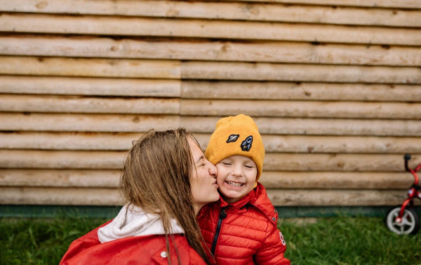 Mum kissing her son goodbye