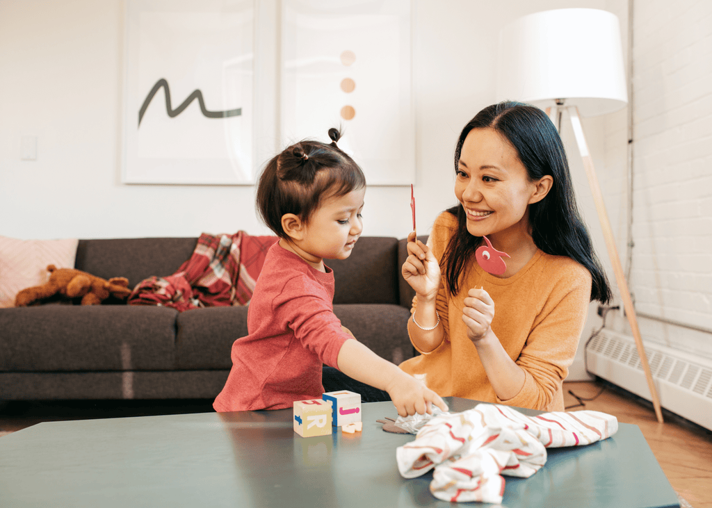 A young mother playing with her toddler child