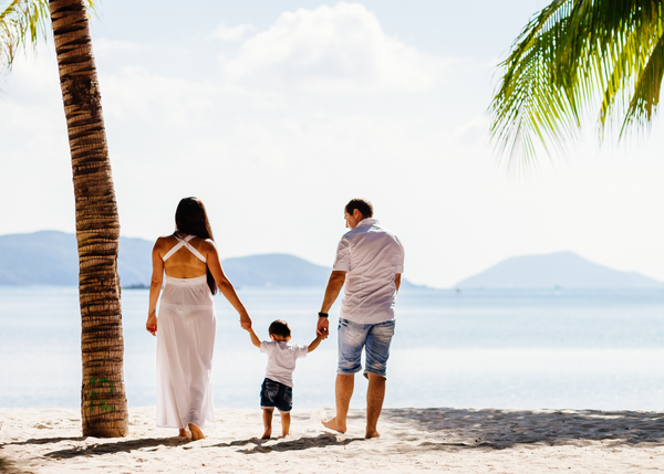 Mother, father and baby together on vacation on a tropical island