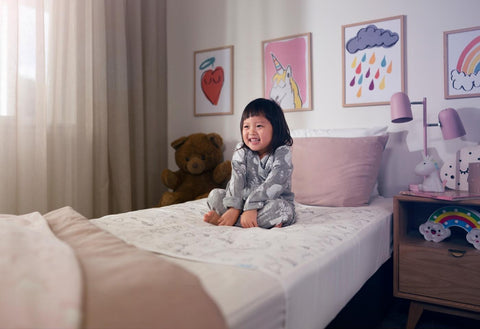 girl smiling on brolly sheets bed