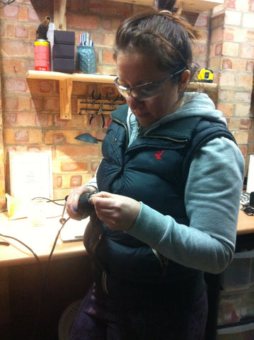 Katie McCann in the Mintique of Cambridge workshop working on a coin ring