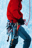 Man with ice climbing tools getting ready to mountain climb