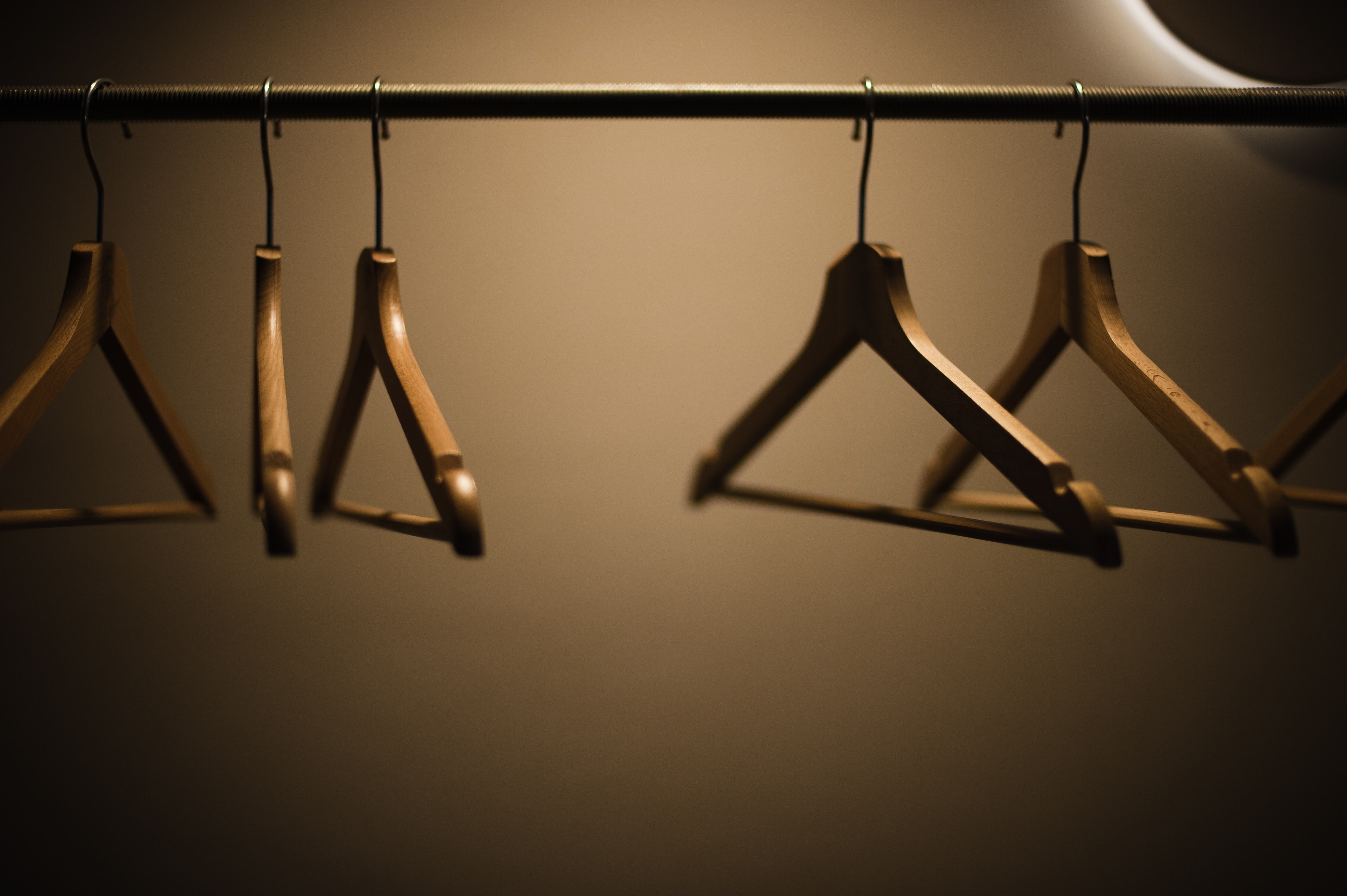Wooden clothing hangers on a rod