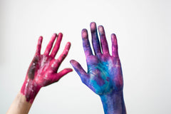 Hands covered in paint