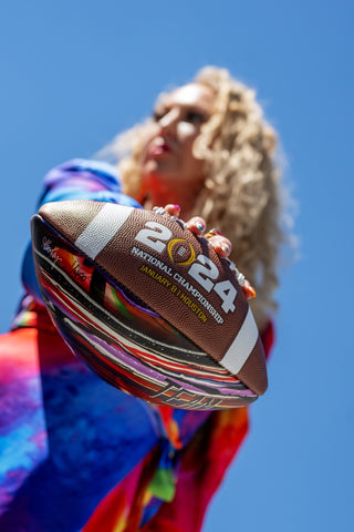 artist holding a football