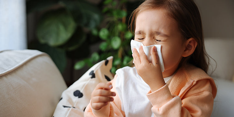 allergy relief from allergy medications image of little girl blowing her nose from having allergies
