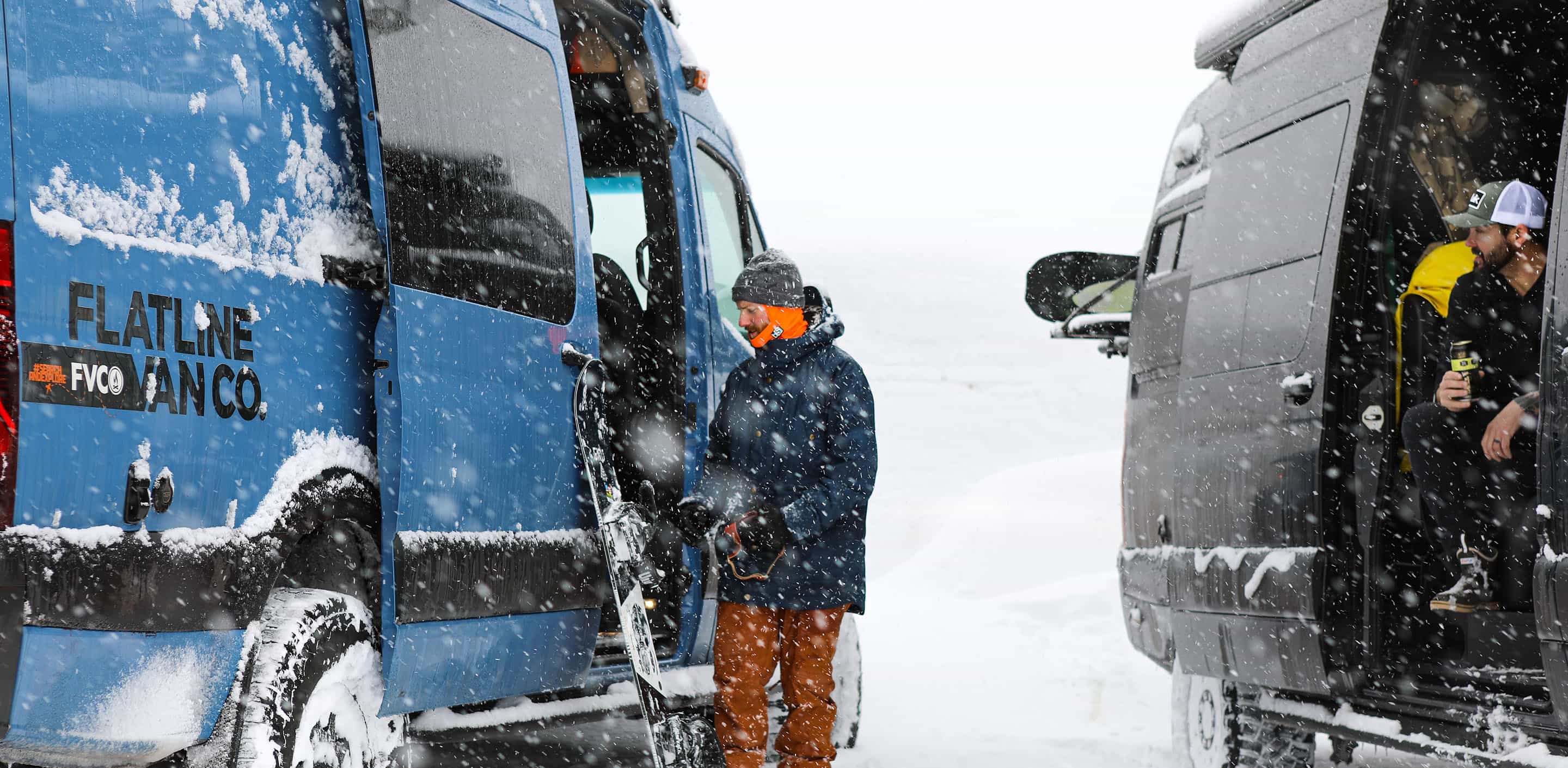 Snowboarder Having Beer In Sprinter Van