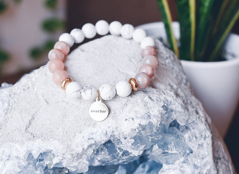 crystal bracelet sitting on a larger crystal cluster