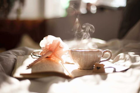 cup of tea on a book with a flower
