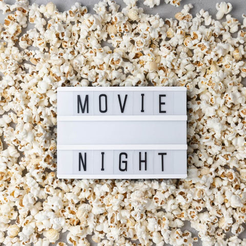Popcorn scattered around a sign that says 'movie night'