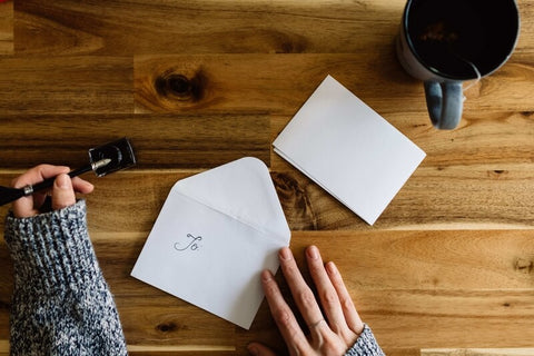 A woman addressing an envelope