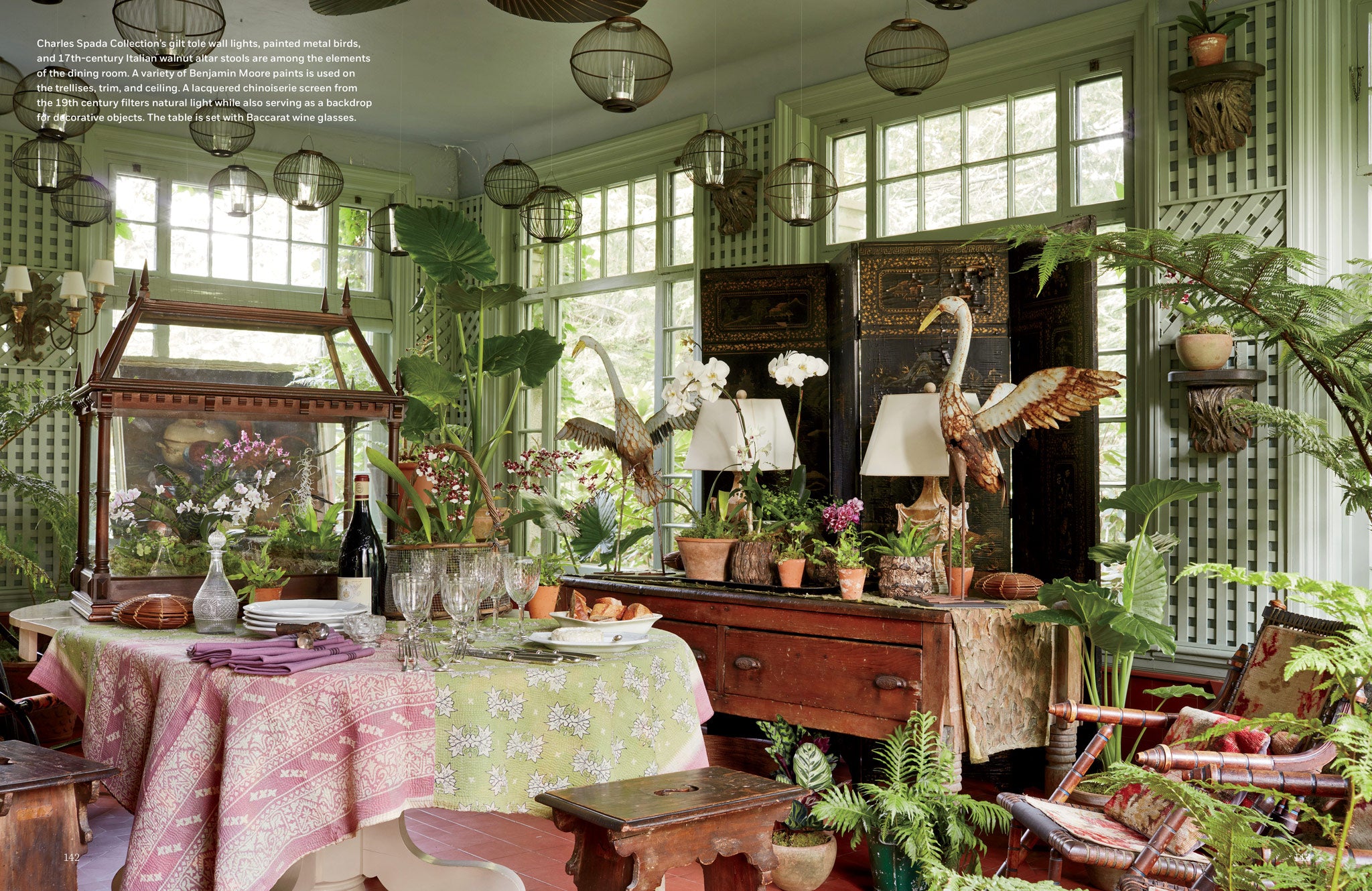 milieu-mag-spread-photograph-of-dining-room-with-green-benjamin-moore-painted-trellises-wooden-furniture-and-antique-birds