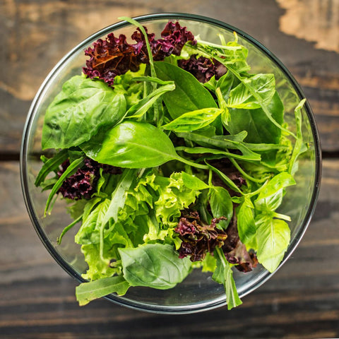 Green salad leaves shown as an example of vegan food