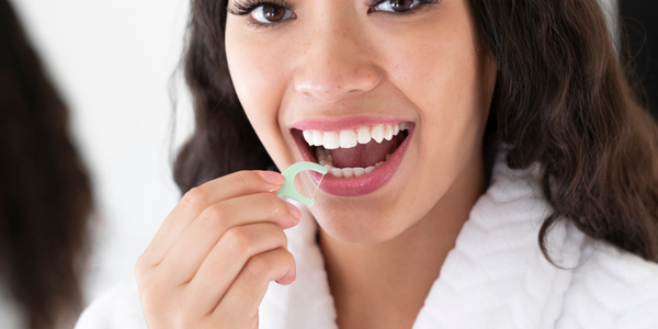 woman flossing teeth