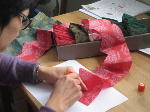 Making Paper Hats at Elves' Best Christmas Crackers. Article written by Nancy White, Toronto Star News