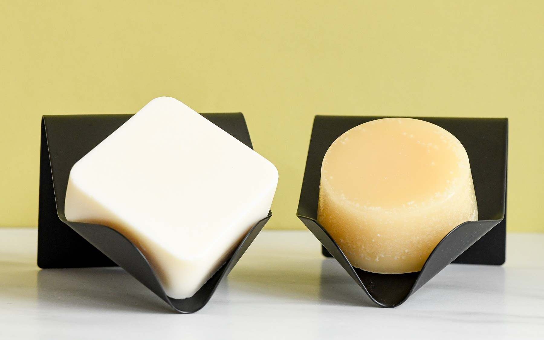 Dip Shampoo & Conditioner Bars on Black Draining Dishes