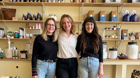 The three team members of Asheville's refill shop Ware stand together for a group photo inside the store.