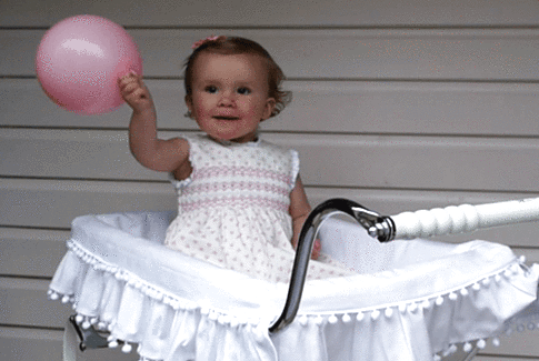 Infant girl playing with balloon