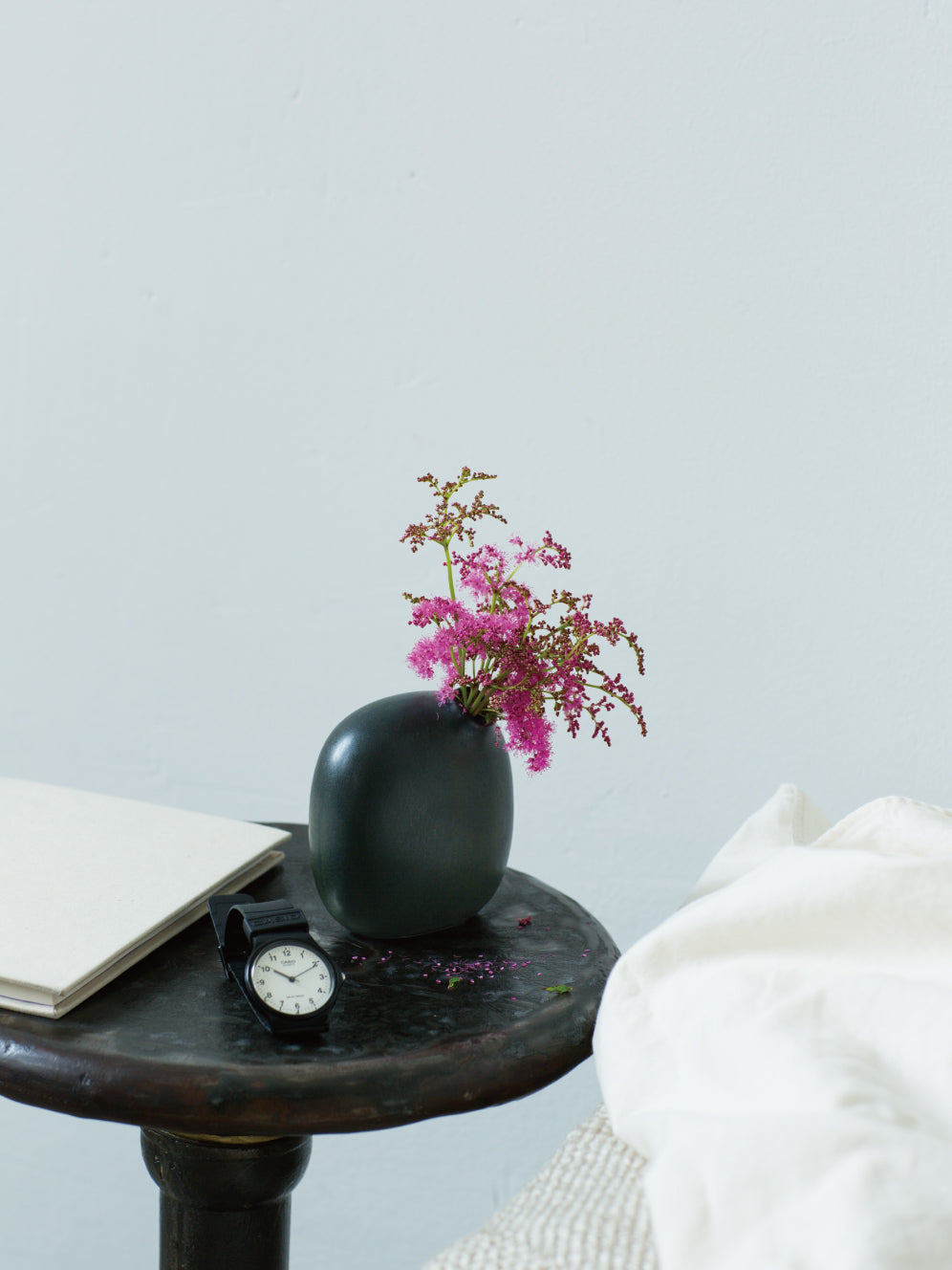 SACCO vase porcelain with single flower on a bedside table 