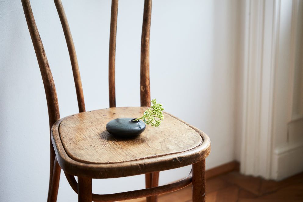 SACCO vase porcelain on a wooden chair 